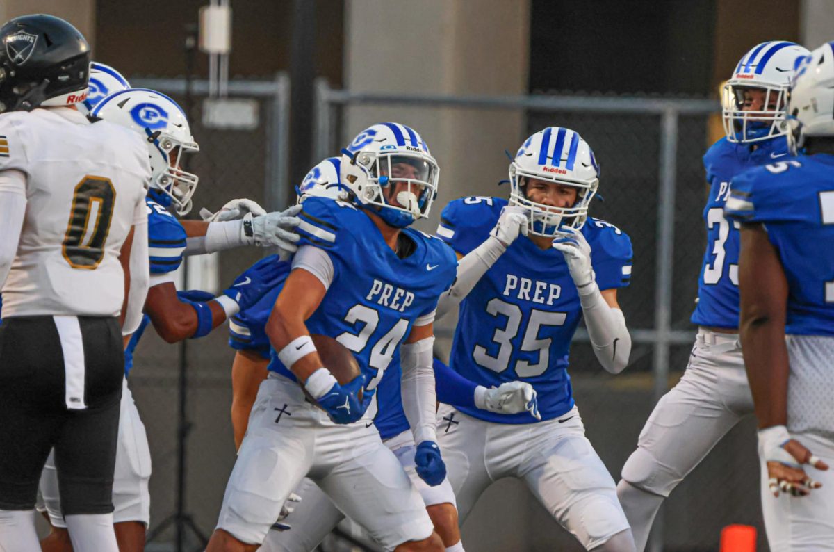 The Junior Jay defense celebrates after Preston Woodward intercepts Tre Bollen