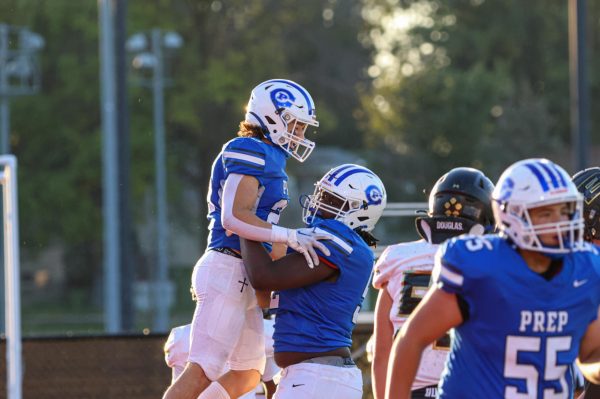 Jacob Ruby is lifted into the air after scoring a touchdown.