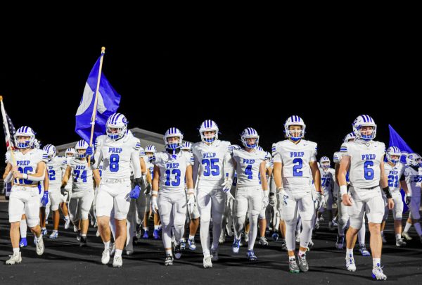 The Junior Jays March Toward the Field Before Their Loss to Elkhorn South