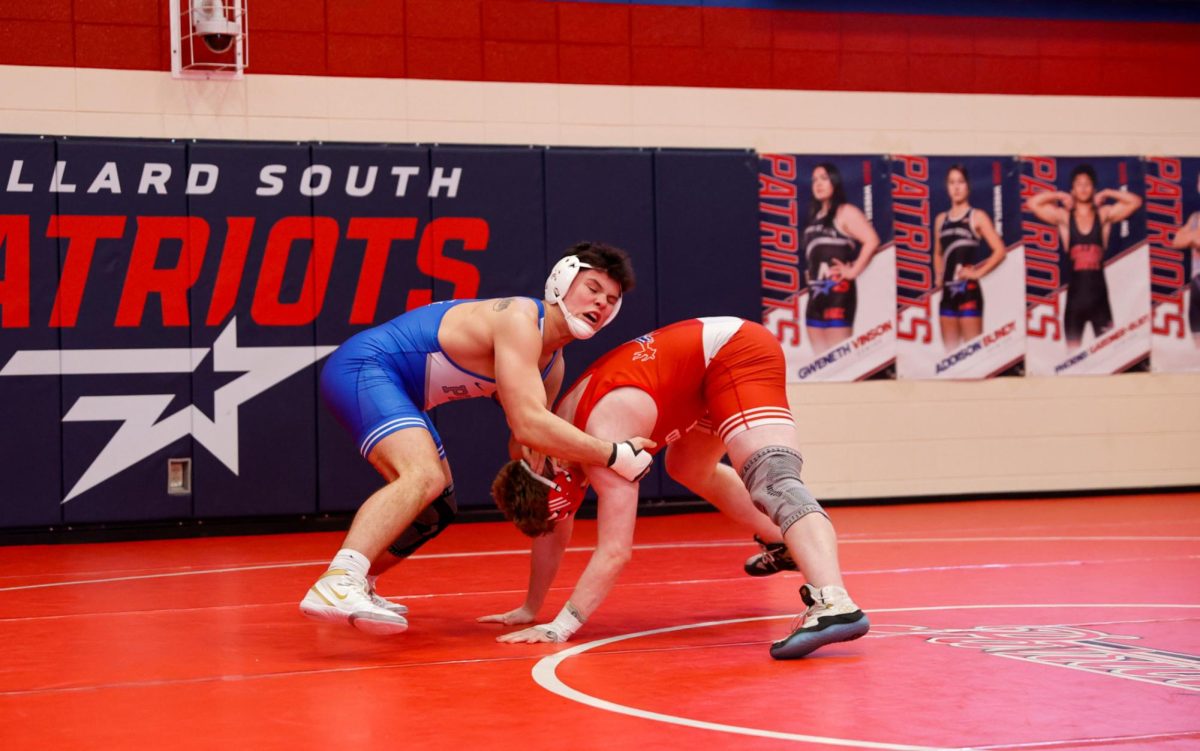 Adonis Bonar II prepares to toss his opponent during a meet at Millard South